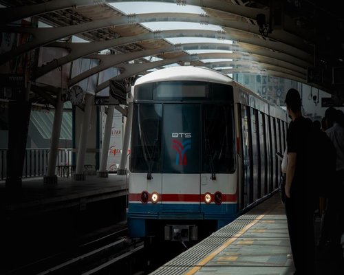 A scenic view of passengers smoothly commuting via Bangkok BTS train over the cityscape